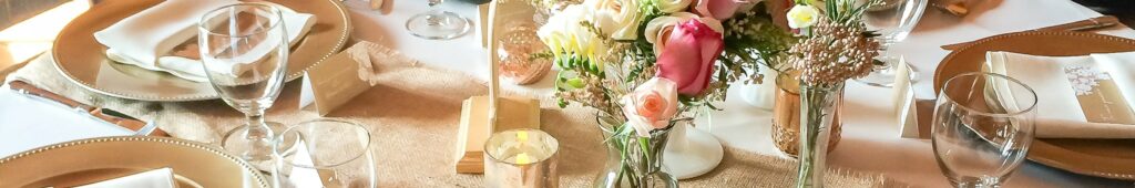 Table setting with a bouquet of roses in the center